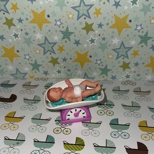 Zuru my mini baby purple scale with blue pad and baby with diaper only.